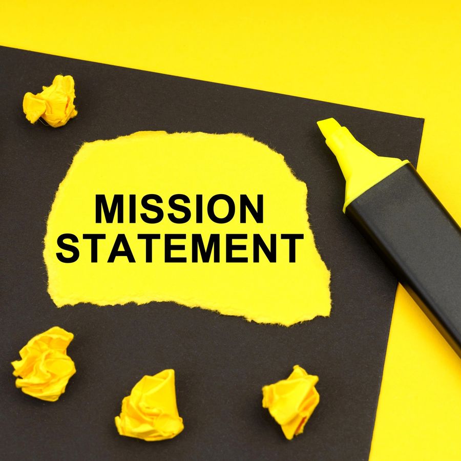 Bold mission-themed typography on yellow paper over a dark surface.